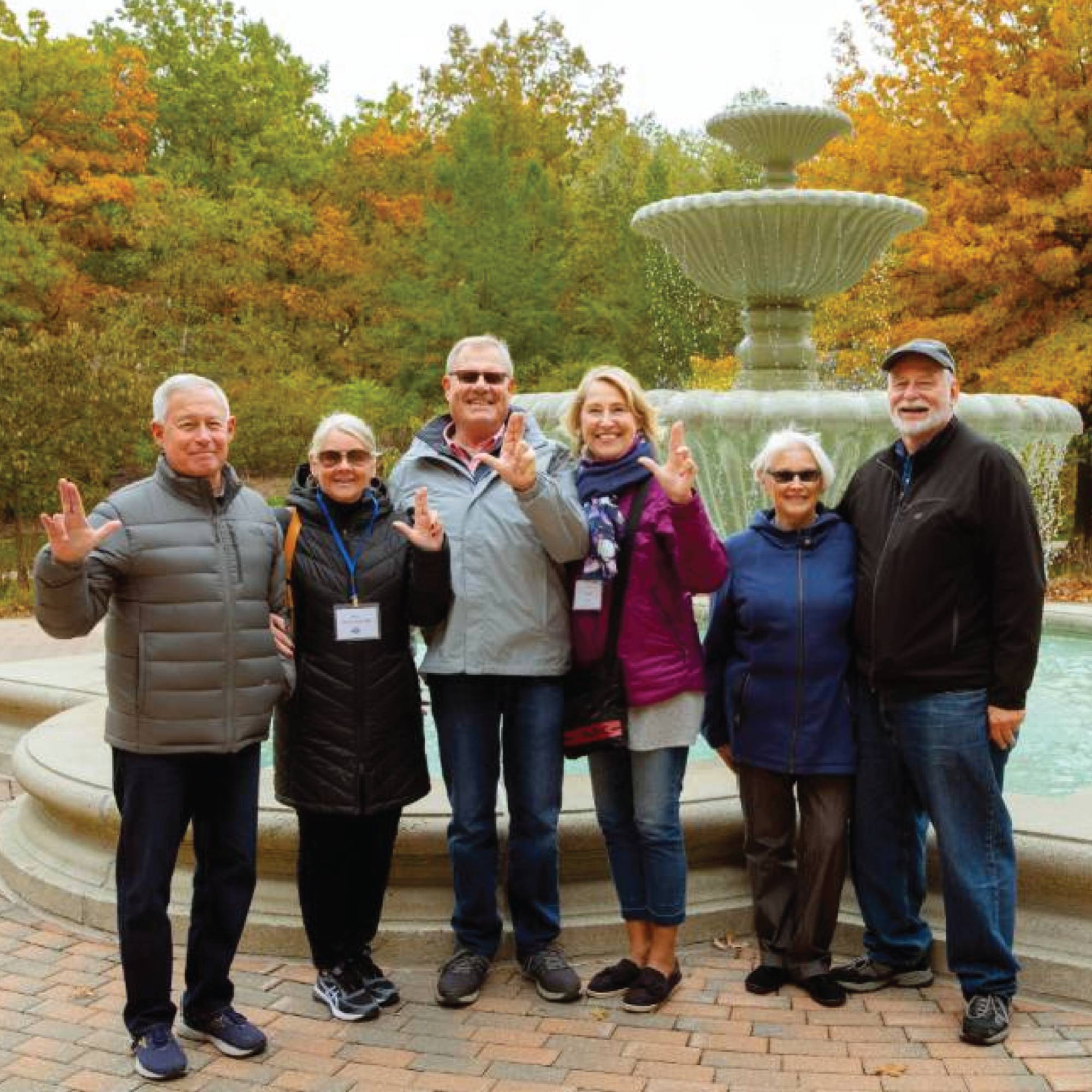 Photo of a group of alumni in front of the fountain on GVSU's Allendale campus